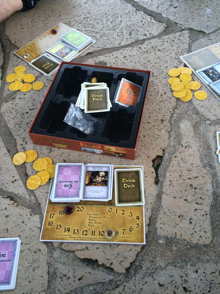 [Image shows a board game placed on stone. It shows a board with the deck "Eve The Illusionist" on it]