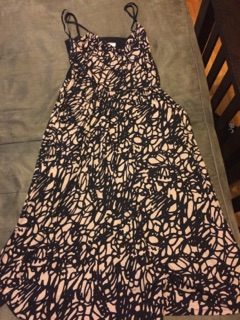 [Image shows a dress being laid out flat. The dress is a two strap dress that's black and beige. The pattern is a geometric print]