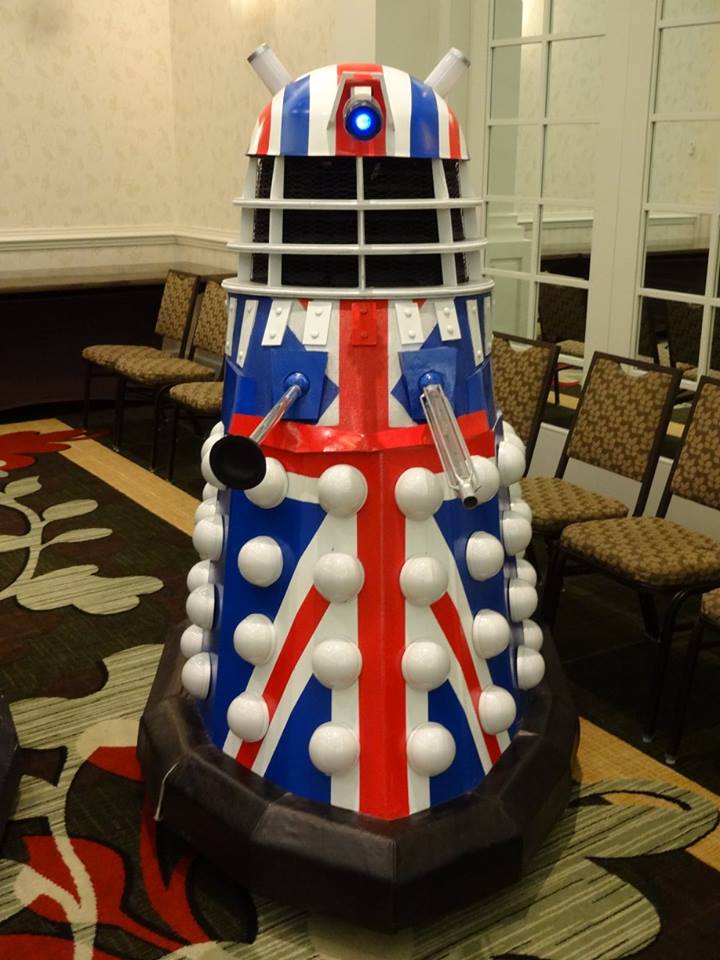 [Image shows a Dalek with a British Flag pattern. The Dalek is a robot with a plunger sticking out of it.]