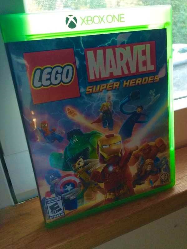 [Image is a video game cover. The video game is LEGO Marvel Super Heroes]