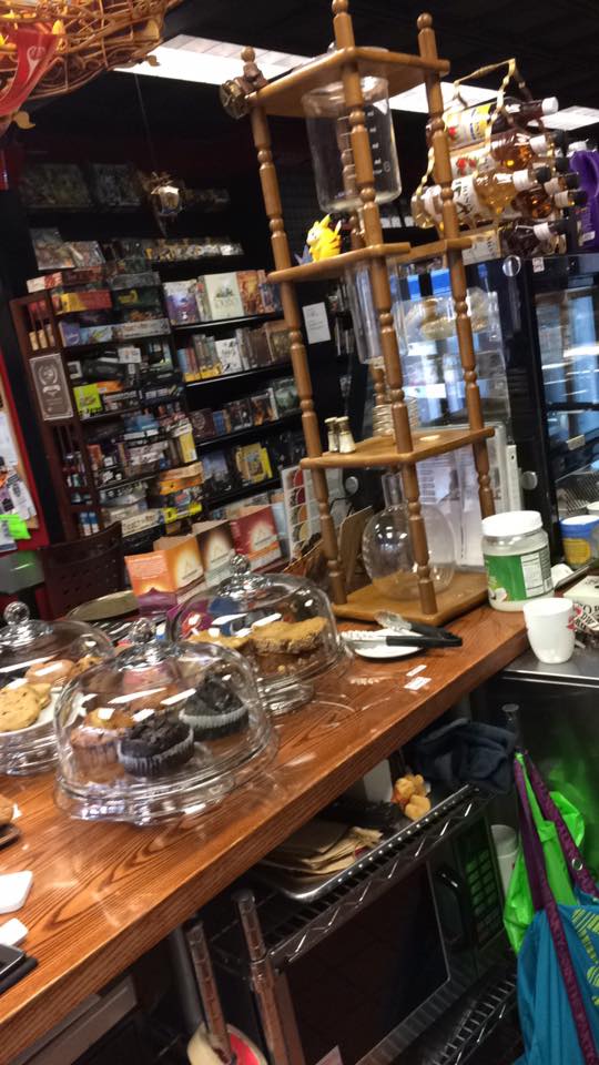 [Image shows a hour glass like device which is used to make iced coffee. There are several treats underneath the glass cases]