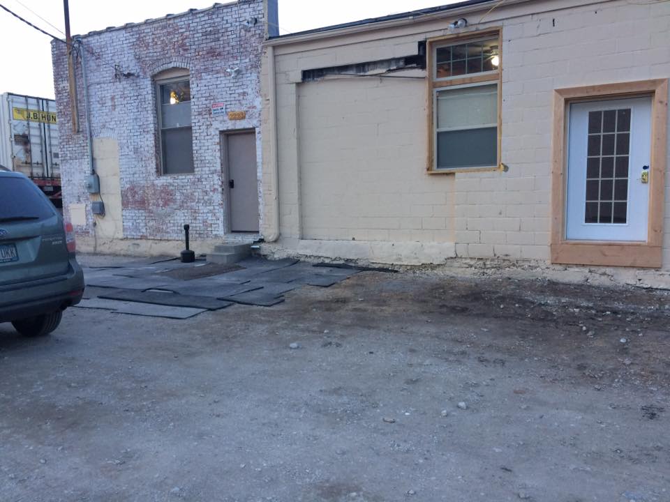 [Image shows a door to walk through. It looks like the building was partially burned down as the building looks broken down]