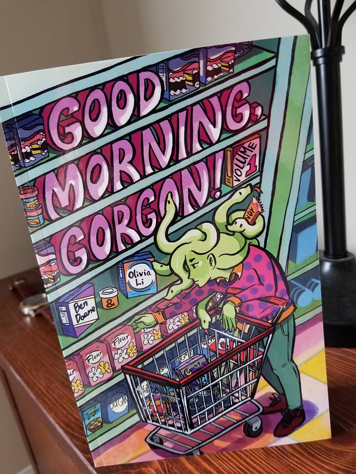 [Image features a comic book cover. It shows a Gorgon (Medusa) like creature at a grocery store with her snake babies grabbing groceries off the shelf.]
