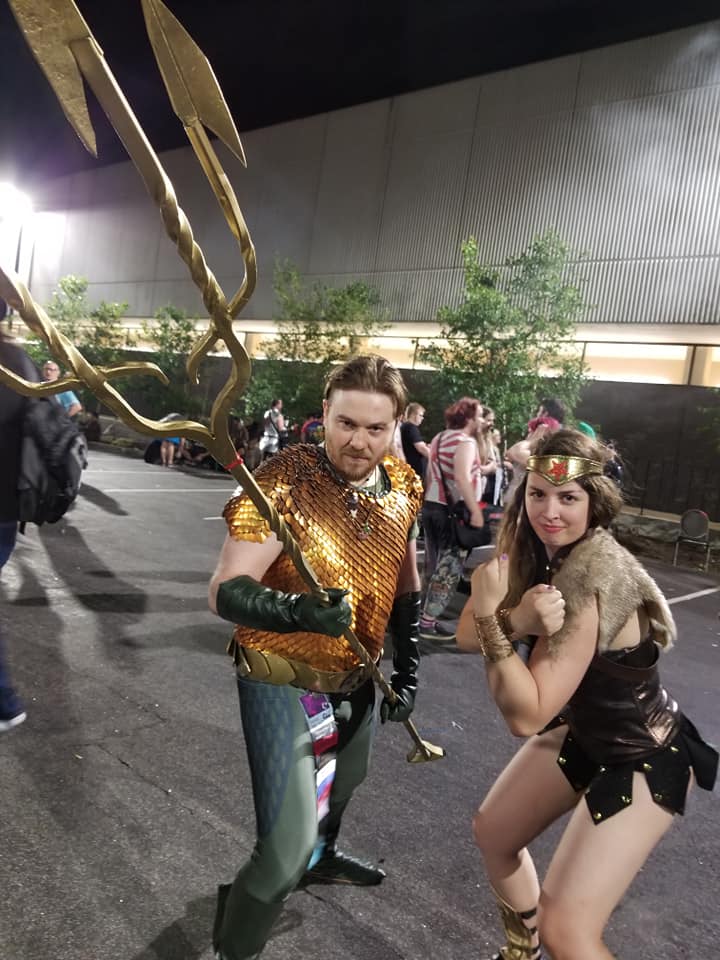[Image is a photo of two cosplayers. One is Aquaman holding a Trident and the other is Viking Wonder Woman]