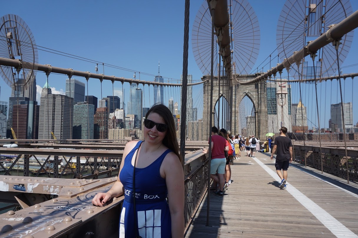 [Image is a picture of me wearing a Tardis dress. I'm smiling at the camera. This was on the Brooklyn Bridge]