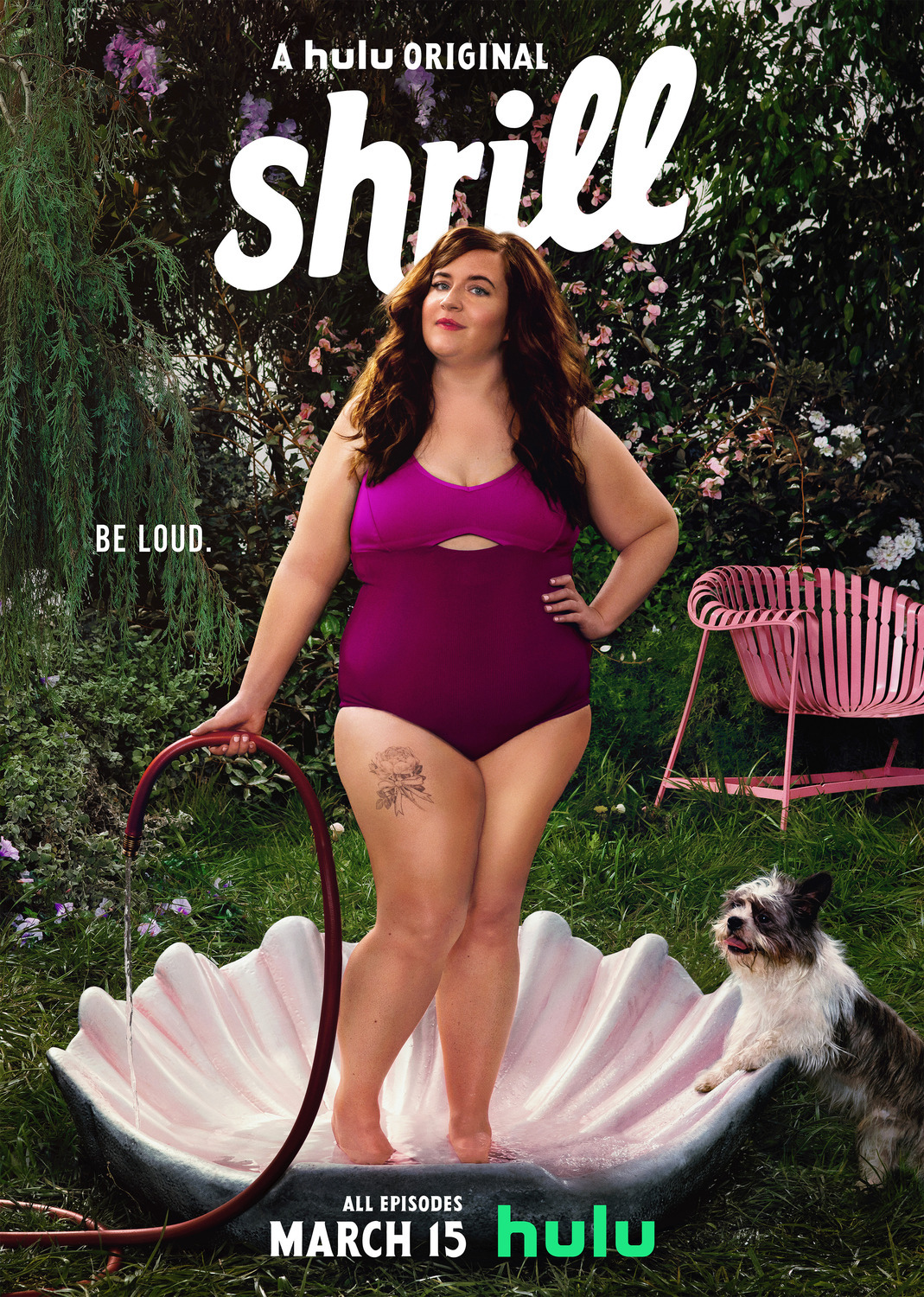 Image is a promotional image for the Show Thrill. It shows Aidy Bryant in a swimsuit standing in a pool the shape of a pink seashell. 