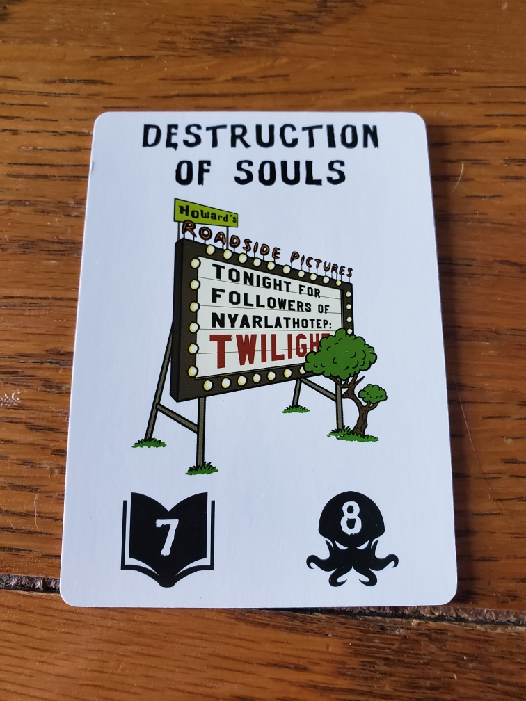 Image is of another card from the game. It says at the top "Destruction Of Souls" The image shows a movie screen from a drive in. It says on the screen "Tonight for Followers of Nyarlathotep: Twilight". 