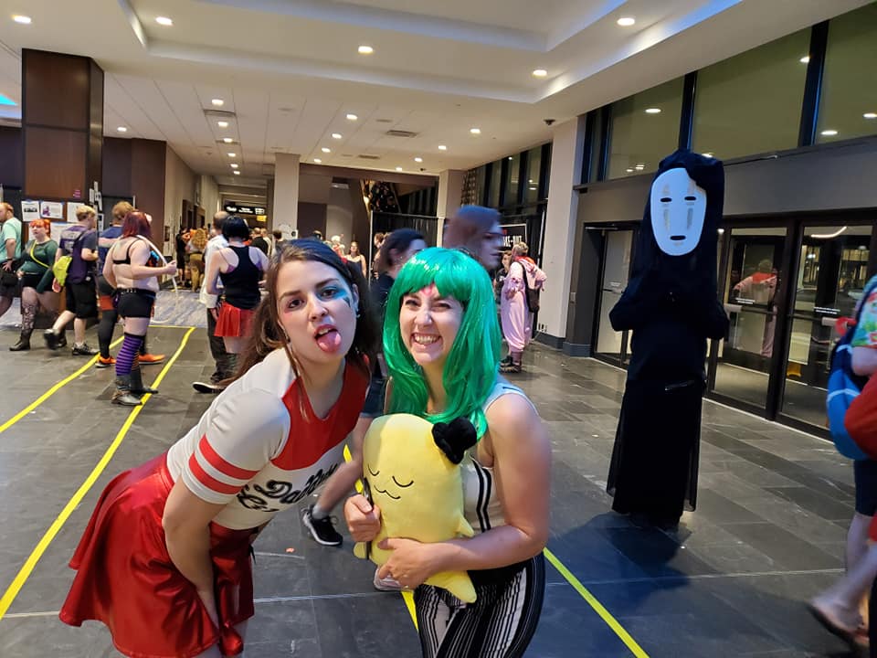 Image is a photo of me and my friend. I'm sticking my tongue out for the photo and she's laughing. 