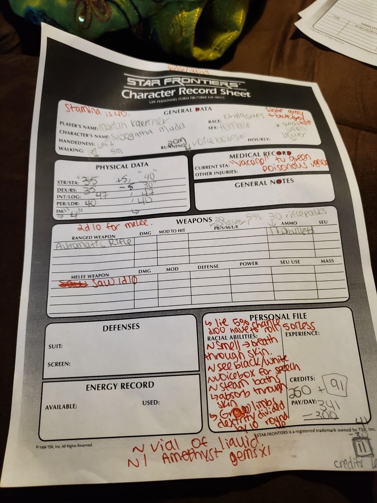 Image is a Star Frontiers character sheet with a mix of pencil and red ink written across the page. It has my player name, physical data, medical record and notes. 