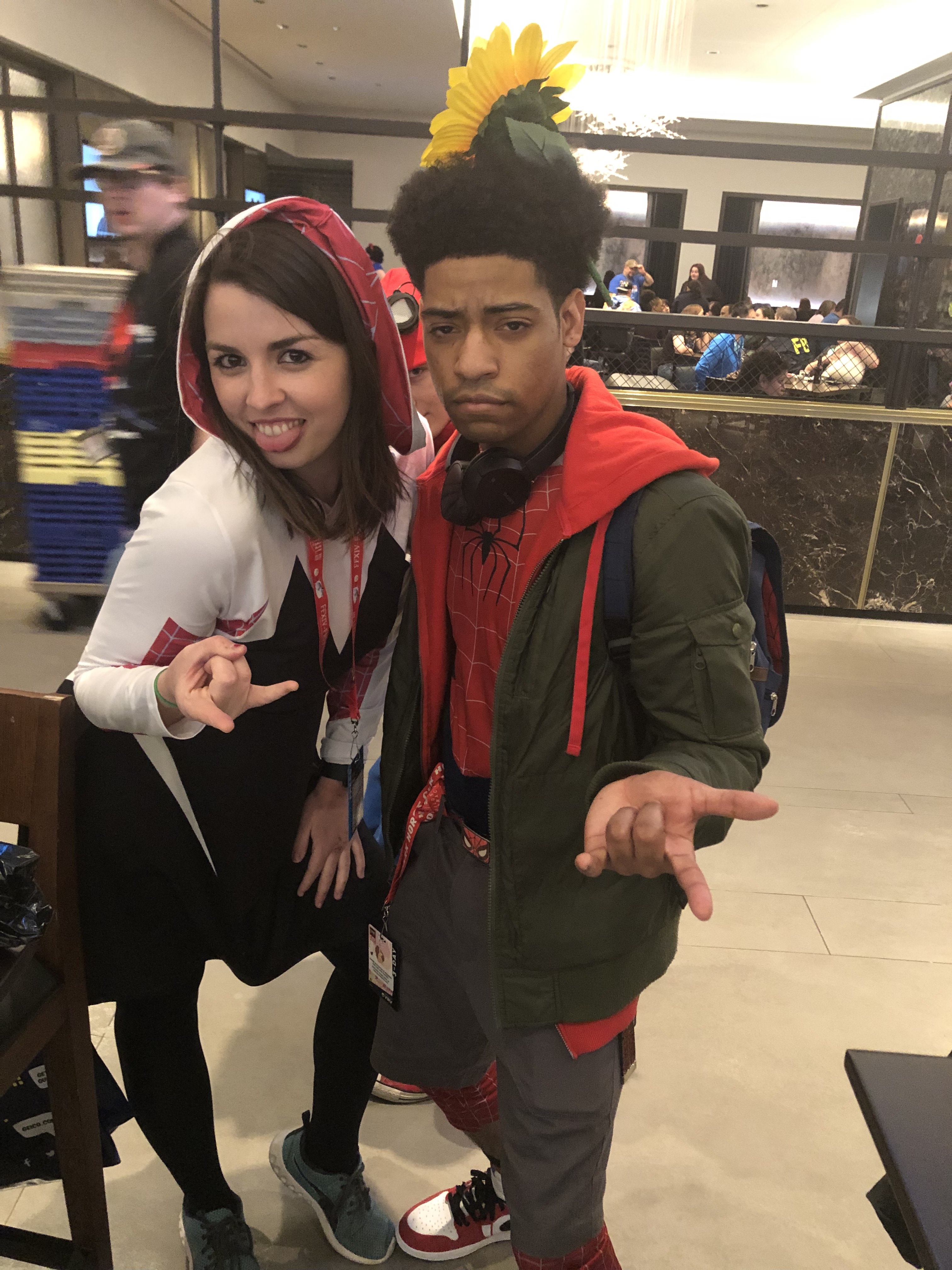 Image is a photo of me as Gwen Stacy and Miles Morales. We both are doing the classic spider-man pose with our hands. 