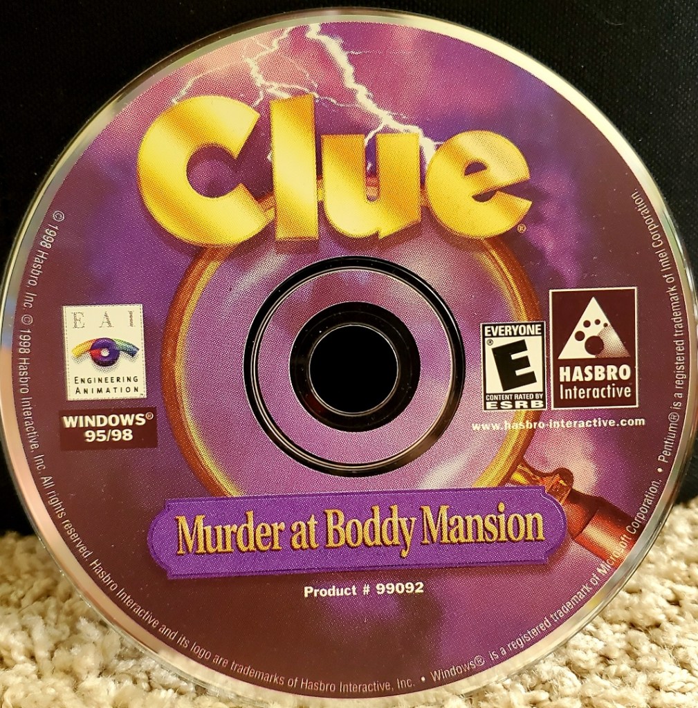Image is a computer CD disc for the computer game, Clue. It shows the words Clue in bright yellow per the branding of the board game. In the middle of the disc, there's a magnifying glass surrounding the circle hole in the disc. It shows lightning striking in the background.