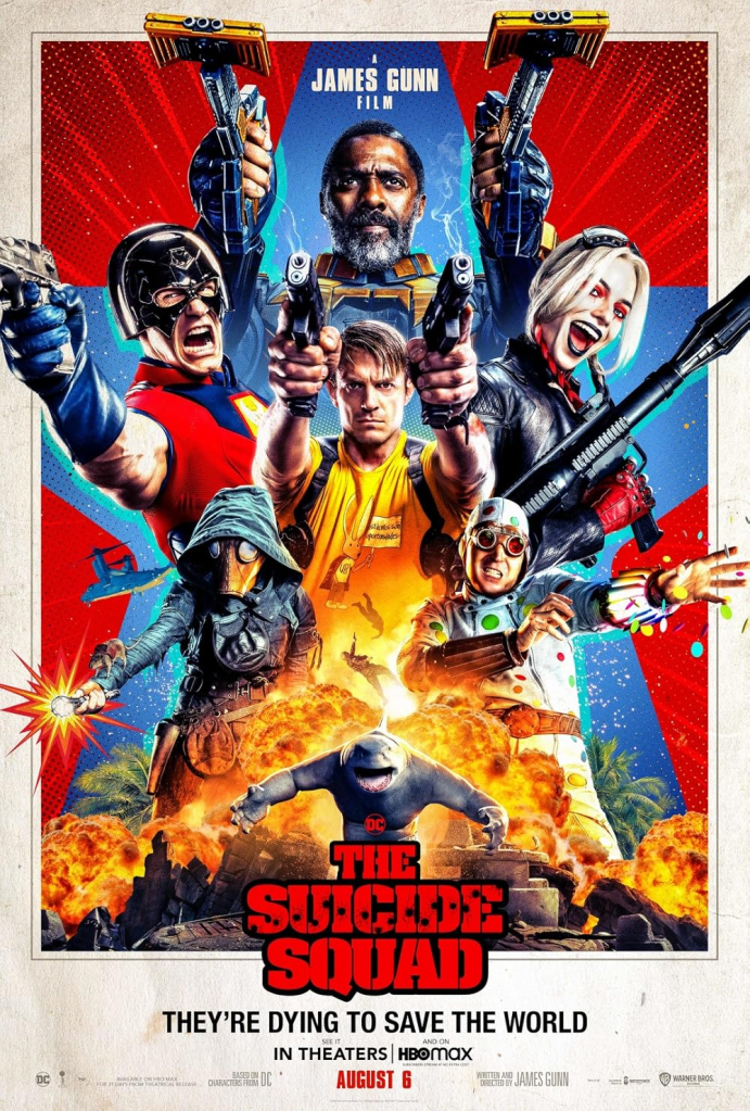 Image is for a movie poster for The Suicide Squad. It shows six people, three are holding guns, one is a holding a rocket launcher. The two at the bottom of the poster - one is holding what looks to be a flashlight, the other is shooting polka dots out of his wrists. At the very bottom, there's an explosion of fire and a shark walking towards the viewer. 