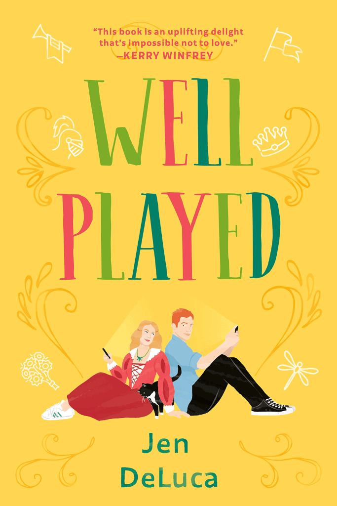 [Image is a book cover "Well Played by Jen DeLuca. There are two people sitting with their backs against each other, but heads turned at each other. A black and white kitty is between them.]