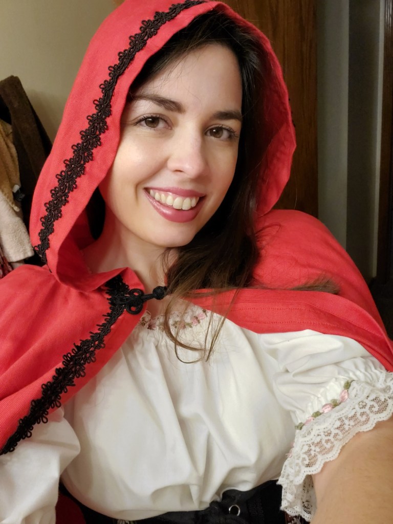 [Image is a selfie of a woman wearing a red hood.]