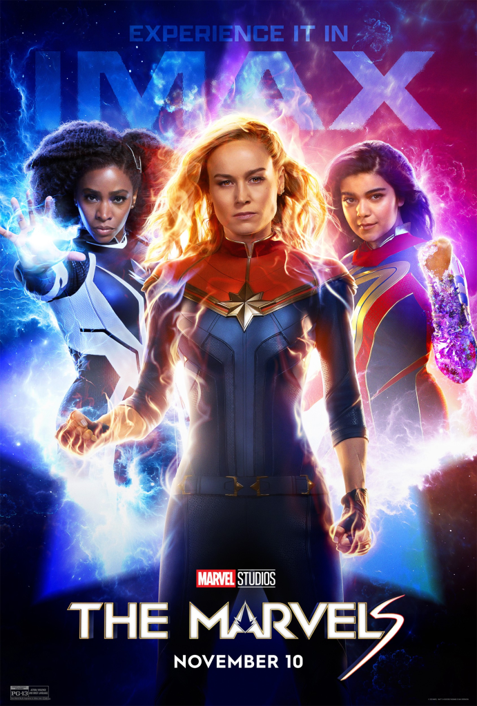 Image is a movie poster for The Marvels. It shows the three main stars (from left to right) Monica Rambeau, Carol Danvers, and Kamala Khan. 