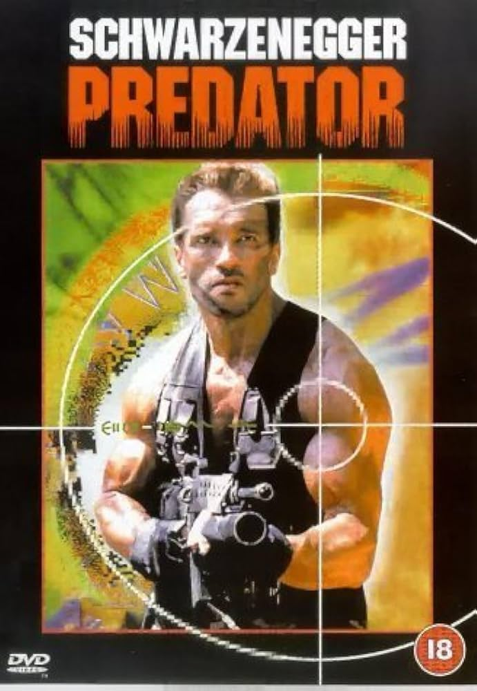 Image is a movie poster for Predator. It show Arnold holding his big machine gun with a target aiming on his shoulder. 