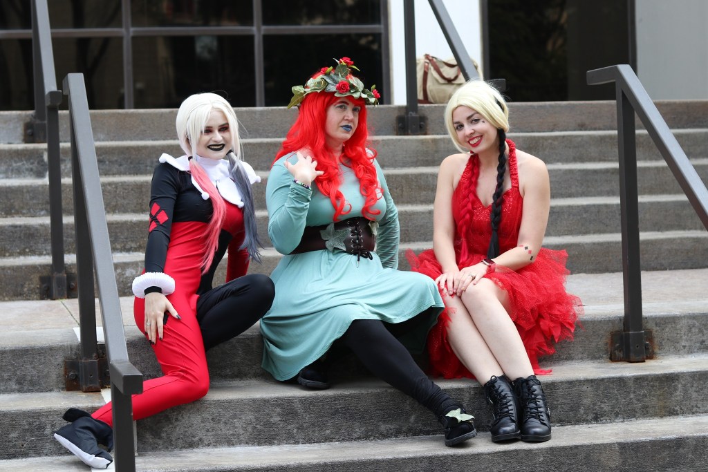 Image is a photo of 3 cosplayers. One is Harley Quinn, one is Poison Ivy, and I'm on the right.