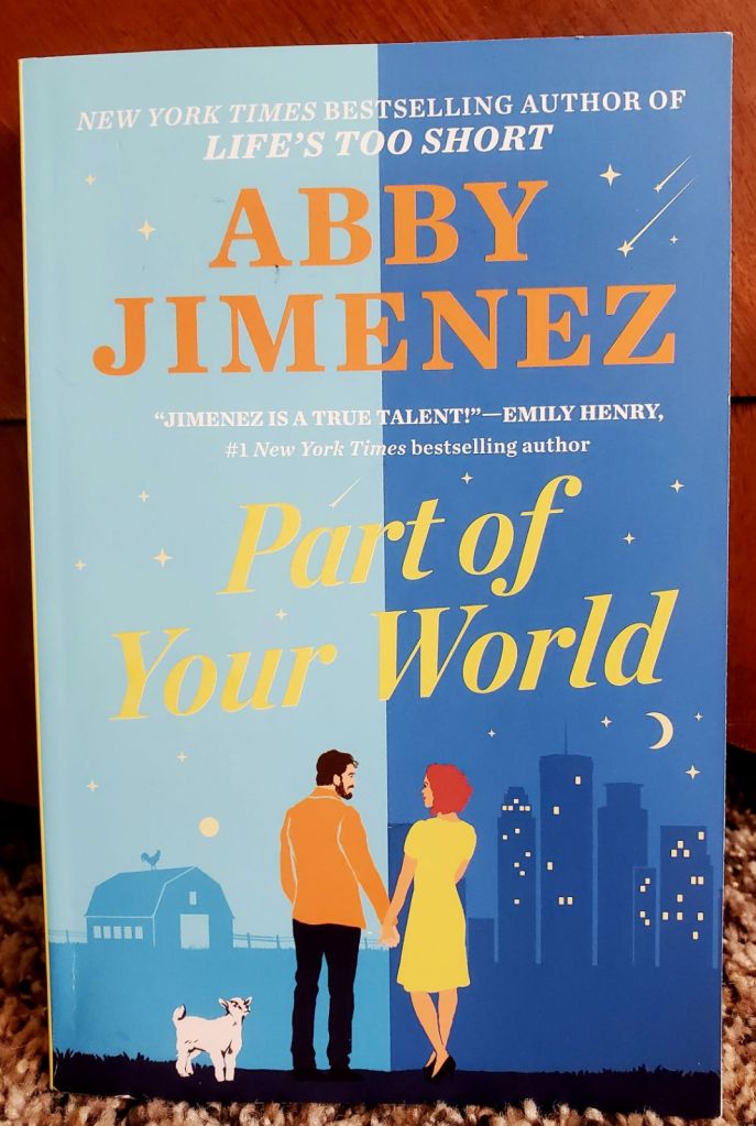 Image is a book cover for Part of Your World by Abby Jimenez. It shows a split cover with the man standing on a farm and a woman standing near a city. They are holding hands.