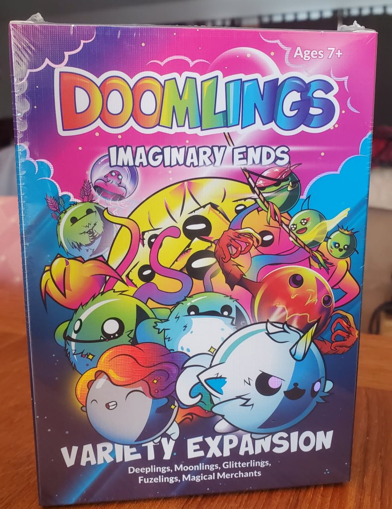 Image is a photo of Doomlings Imaginary Ends. It shows a bunch of cute creatures. One at the bottom looks like a circular narwhal . The one above it looks like a red blob with lightning on it. 