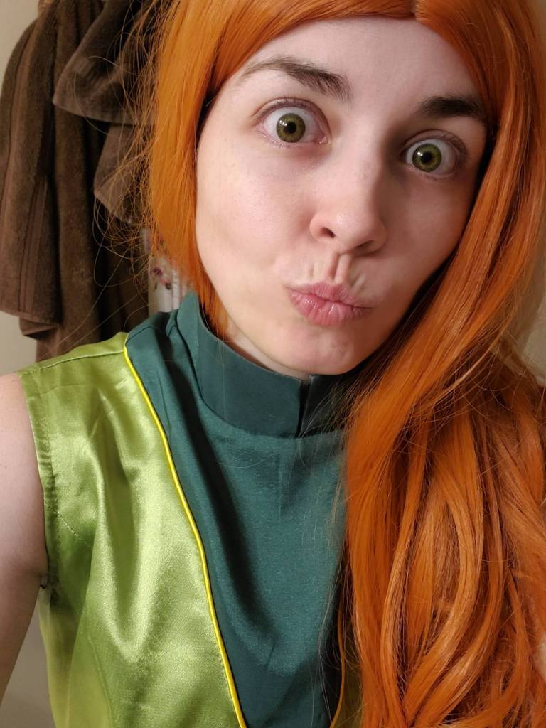 Image is a photo of me, wearing an orange wig. If you look closely at my eyes, they are green because I have my colored contacts in. 
