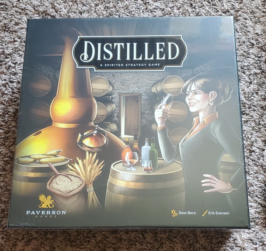 Image is a photo of a board game called Distilled. It shows a woman sampling something alcoholic. She's in a barrel room with a bunch of barrels inside. 