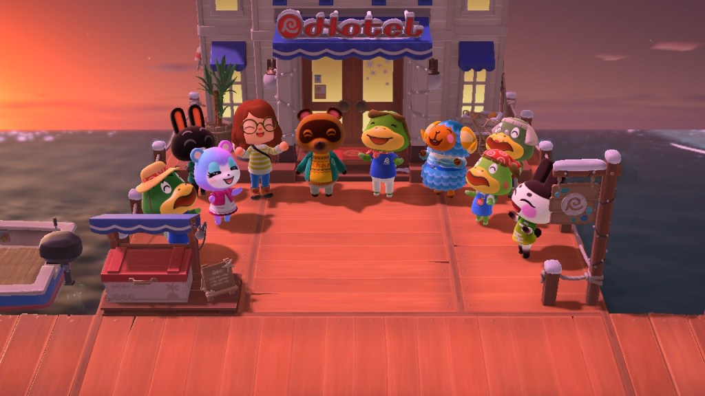 Image is a photo of a screenshot taken in Animal Crossing. There's a hotel that says Hotel on the front of the building on a dock in a pier. In front of the hotel are 10 different villagers. They are celebrating the opening of the hotel. 