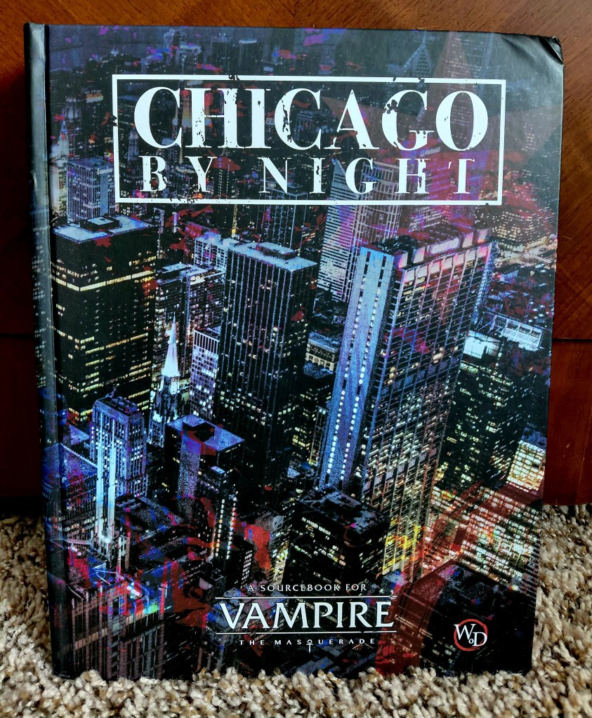 Image is a photo of a TTRPG rulebook. It's titled Chicago by Night. It shows a close up side view of Chicago with magenta coloring throughout the cover. At the bottom of the book it says "A Sourcebook for Vampire: The Masquerade". 